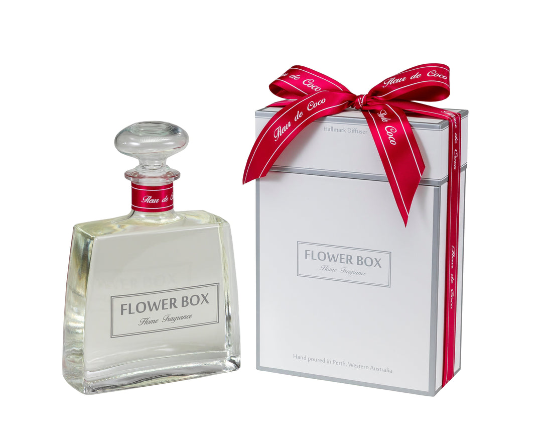 Flower Box Reed Diffuser bottle and packaging with a red bow on a white background