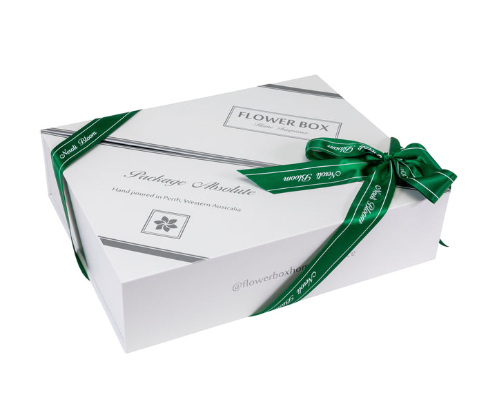 White flower box gift package with a green ribbon on a white background