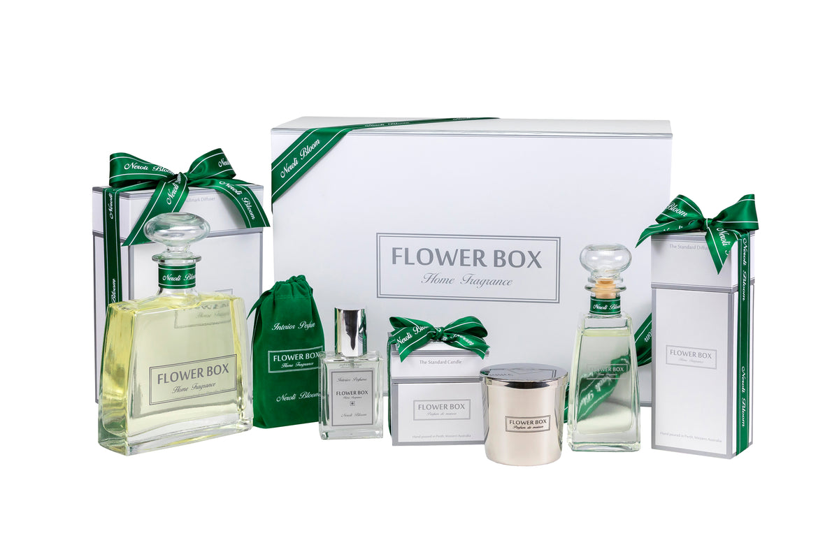 Flower Box interior fragrance gift package set with various products including bottles, a box, and a candle on a white background.