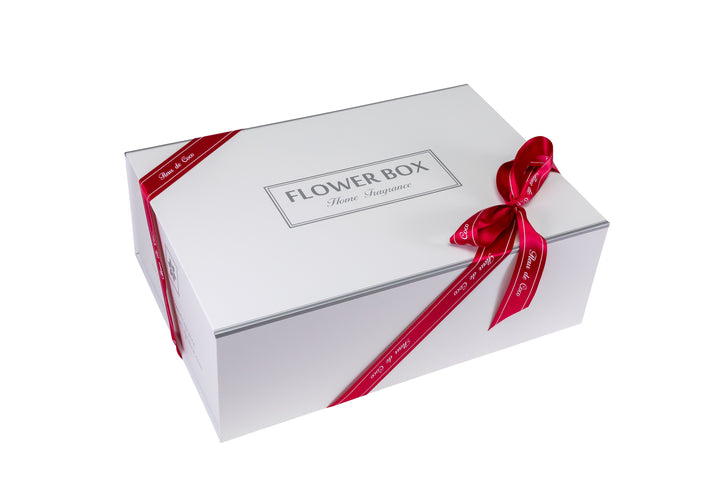 White flower box with a red ribbon on a white background