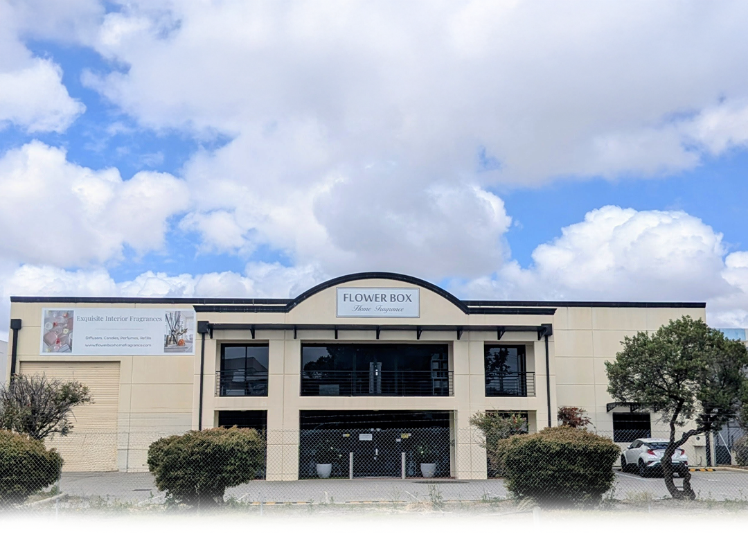 Building with 'Flower Box' sign under a blue sky with clouds
